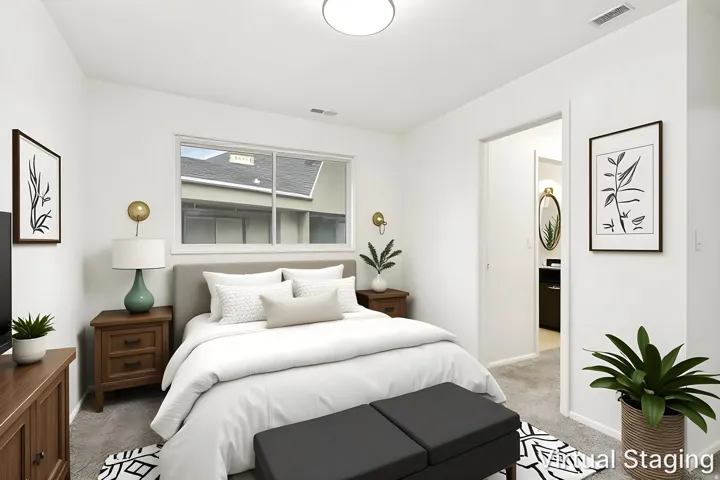 Bedroom with a window featuring exterior views, white walls, and gray carpet flooring