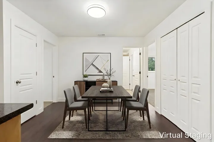 Dining area featuring wood-finish flooring, a contemporary flush-mount ceiling light, and white paneled doors