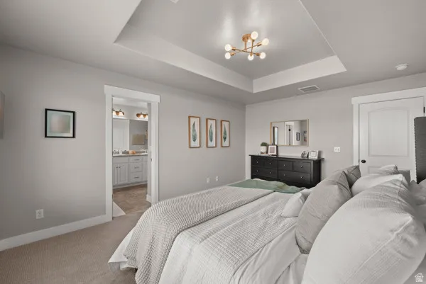 Tray ceiling with a modern light fixture and recessed lighting
