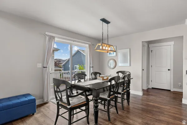 Dining area with wood-finish flooring and light gray painted walls