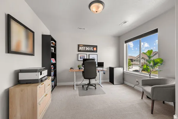 Bright room with neutral wall tones and light-colored carpeting