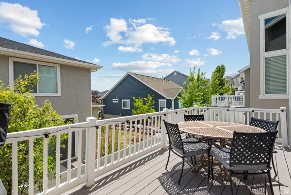 Outdoor deck featuring wood-finish composite decking and white railings