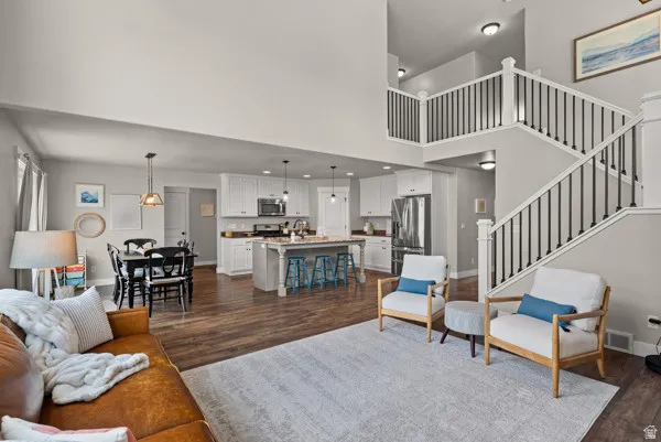 Open-concept living area featuring high ceilings and wood-finish flooring