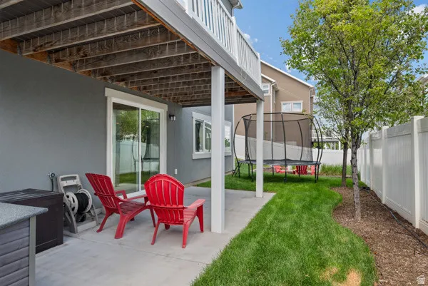 Covered patio space featuring a concrete slab and access to the backyard