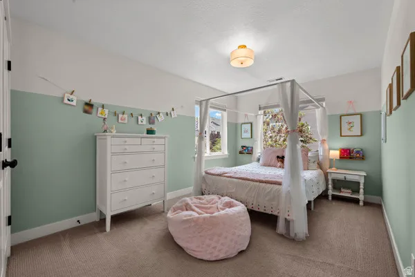 Carpeted room featuring a two-tone wall treatment, white trim, and a semi-flush mount ceiling light