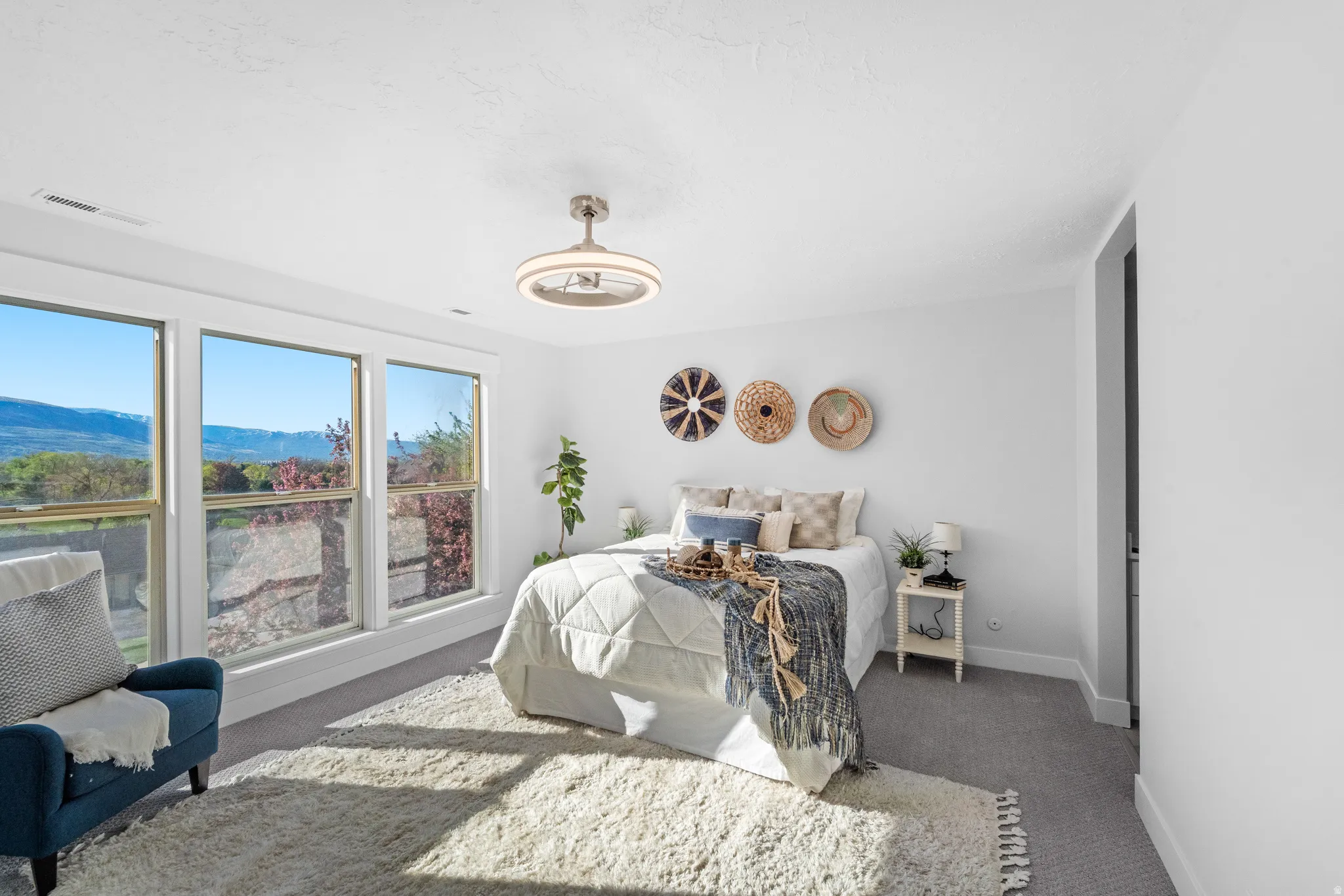 Bedroom featuring triple window assembly, recessed lighting, ceiling fan light fixture, and gray carpeting