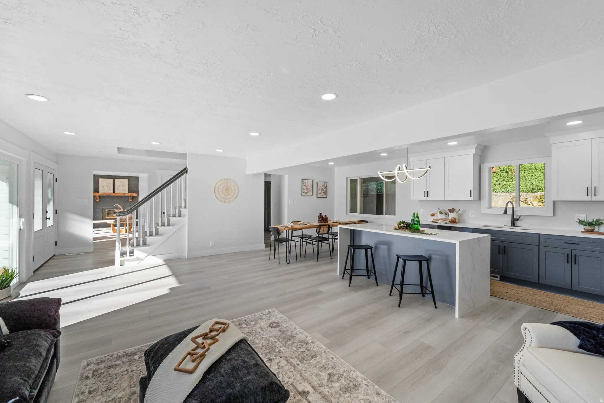 Open-concept living space with light wood-finish flooring