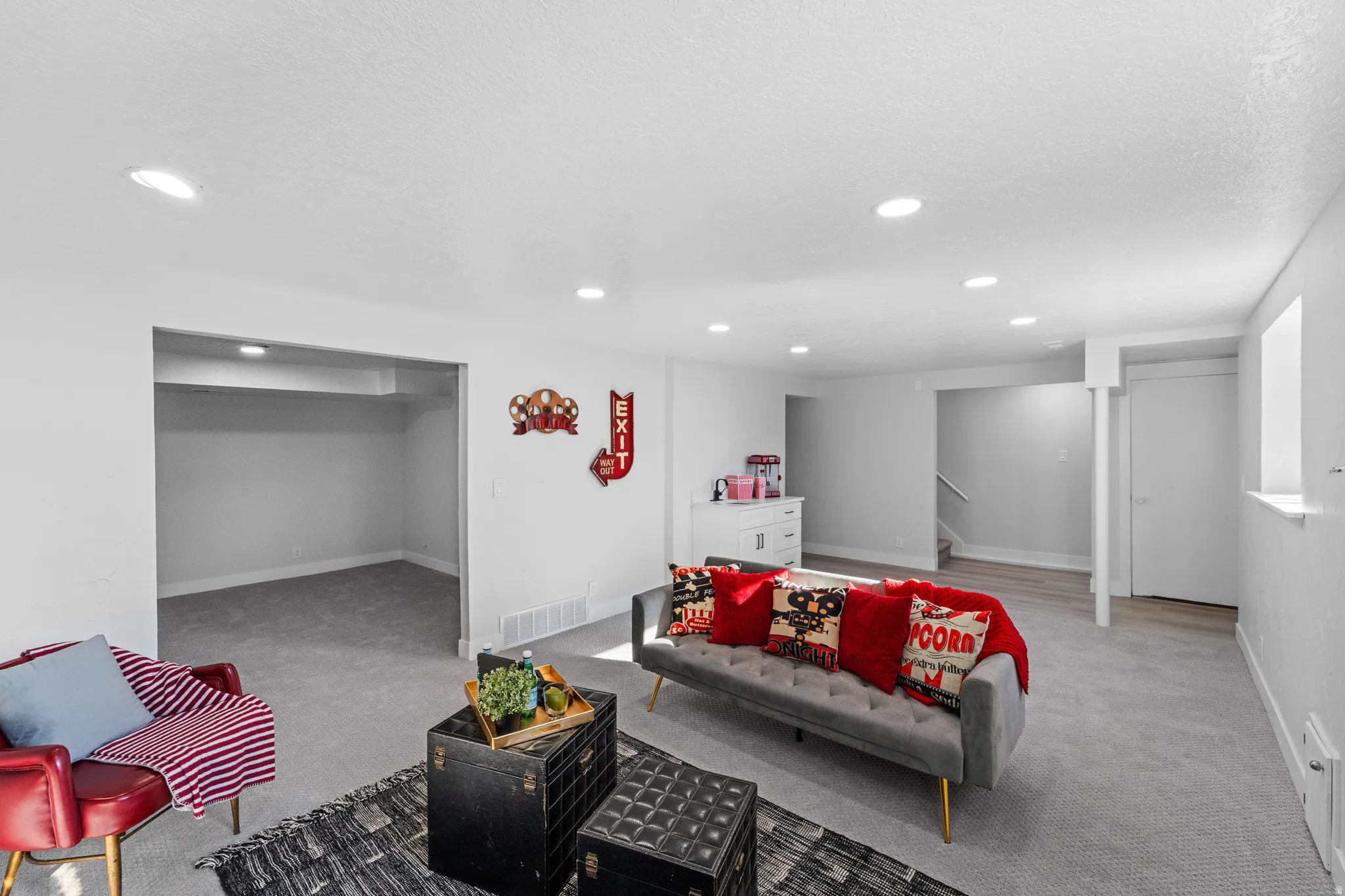 Spacious finished basement featuring recessed lighting, a neutral color palette, and a combination of carpeting and wood-finish flooring