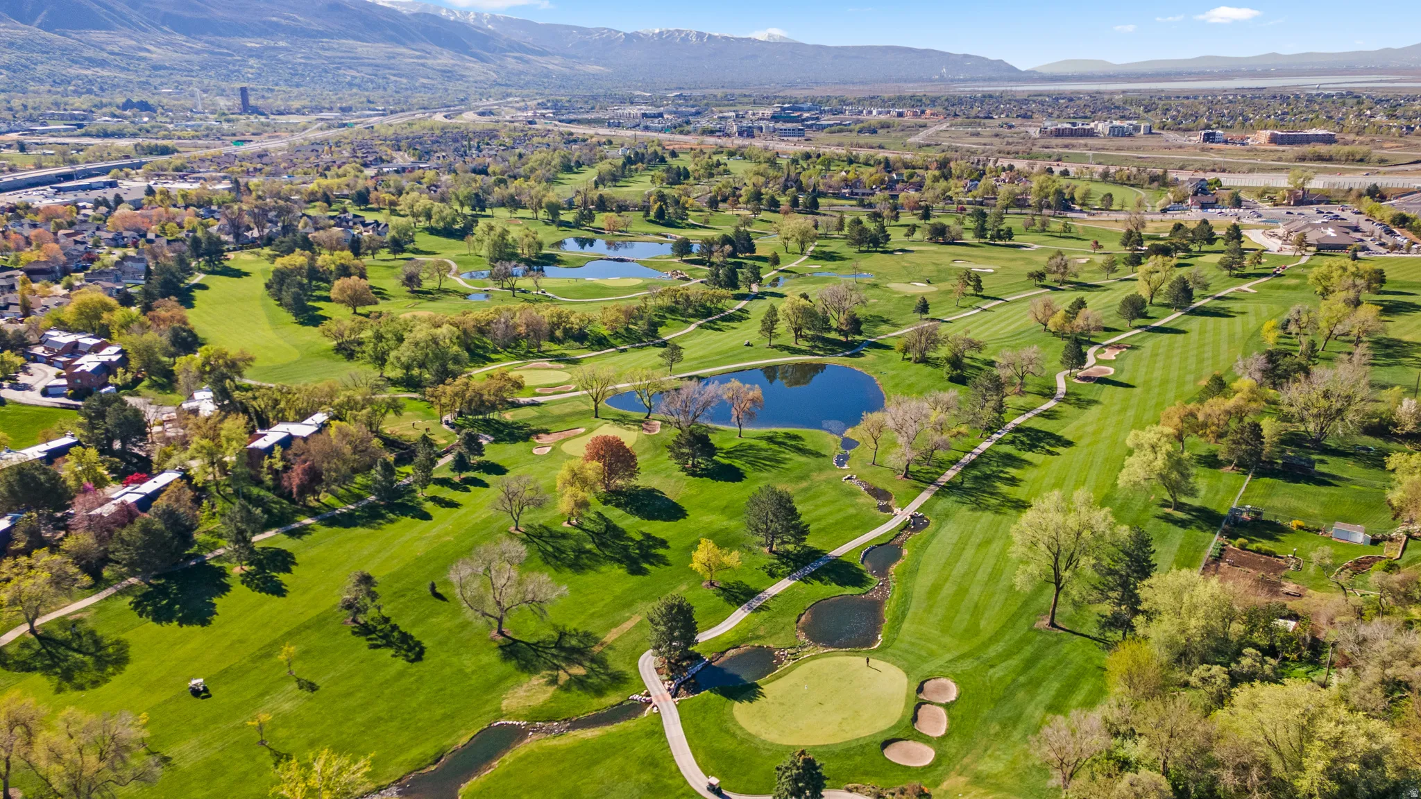 Expansive golf course featuring multiple greens, sand traps, water features, and manicured fairways