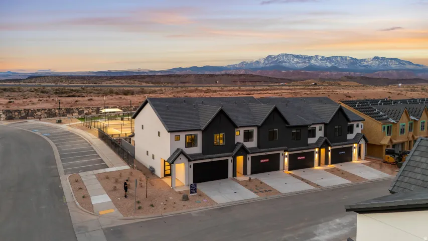Contemporary townhome exteriors featuring dark siding, light stucco, and dark tile roofs