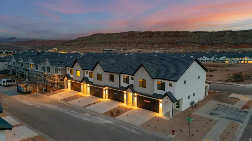 Contemporary townhome exterior featuring clean lines and a white stucco finish