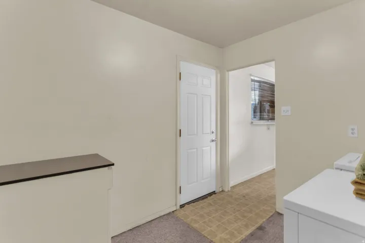 Utility area featuring a paneled interior door, neutral wall paint, and a built-in counter surface