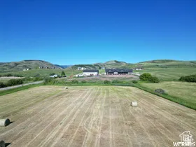 Expansive land parcel featuring open fields and distant hills