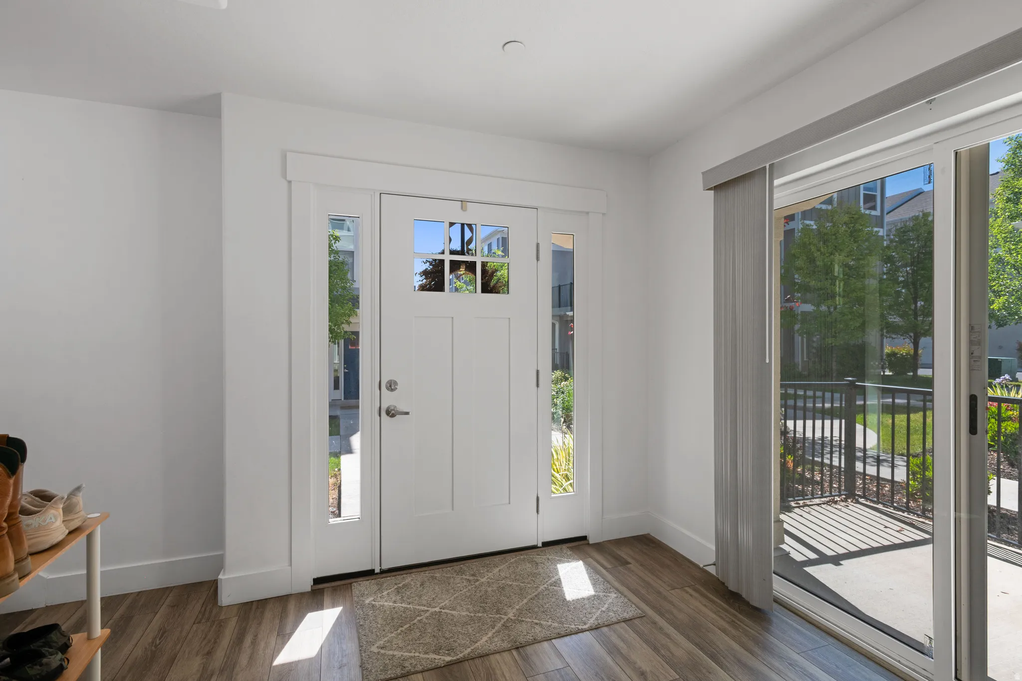 Entryway featuring a paneled front door with decorative glass, side lites, and transom window