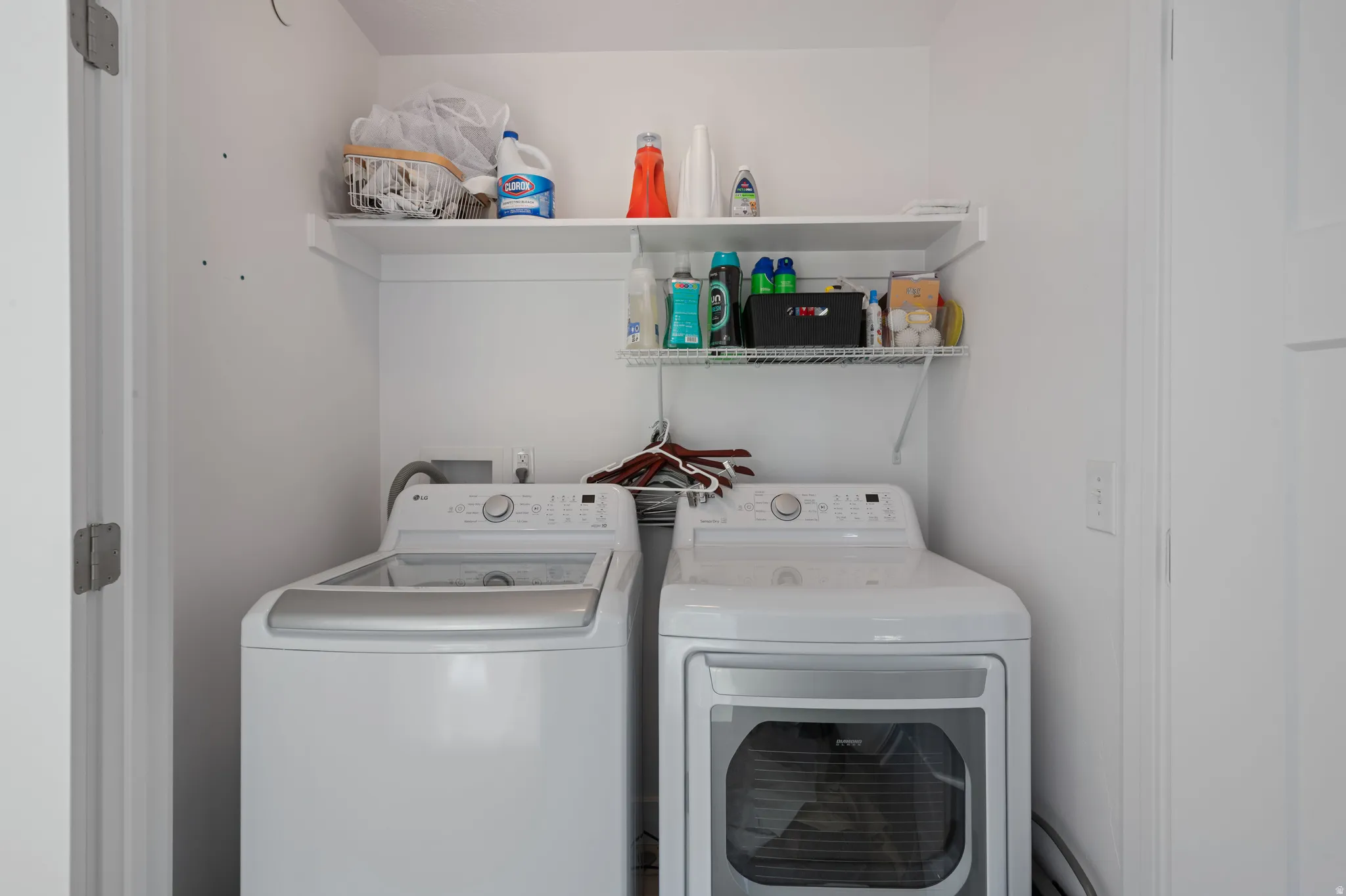 Dedicated laundry area featuring a white top-load washer and a white front-load dryer