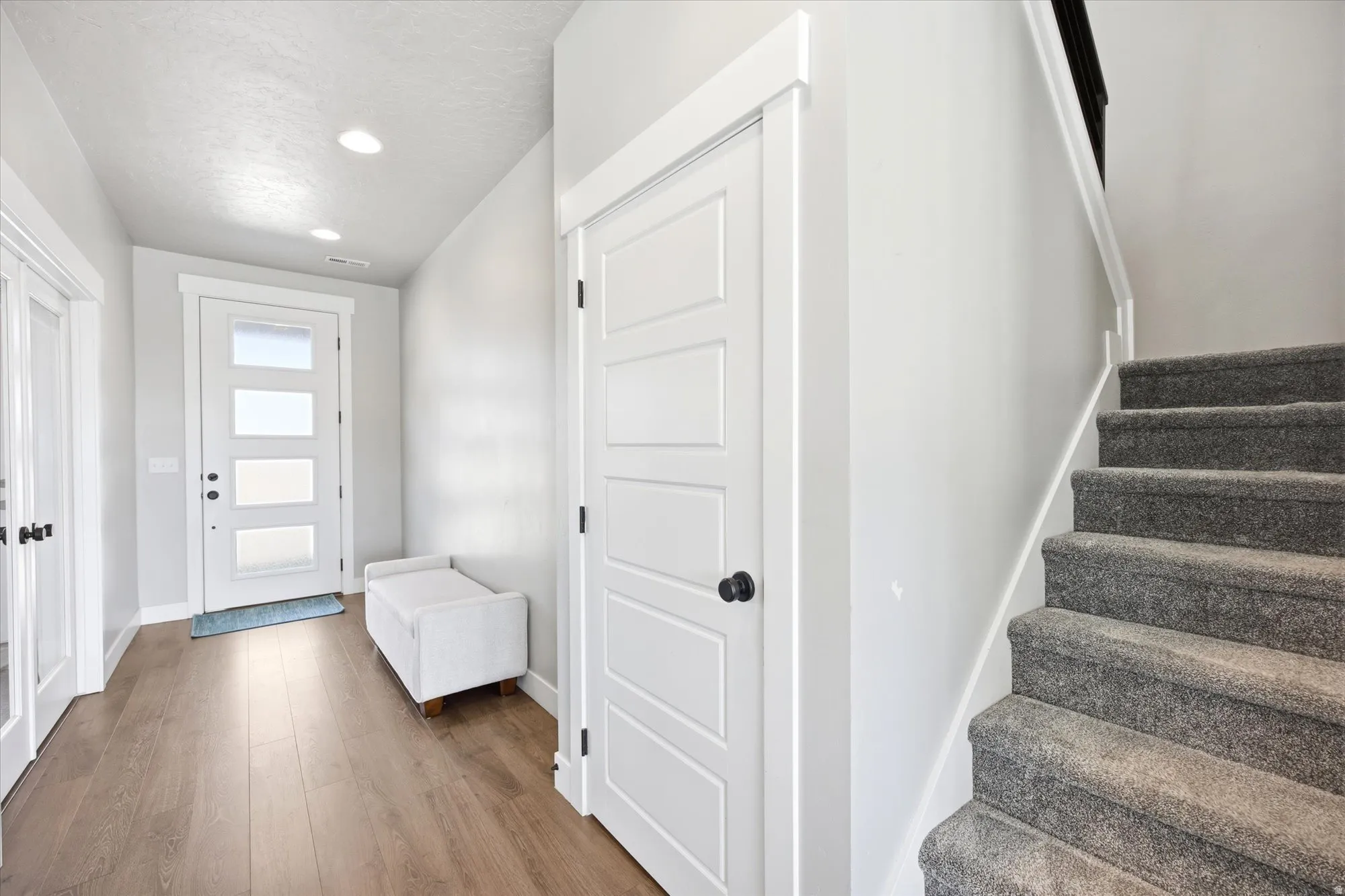 Entryway featuring wood-finish flooring and recessed lighting