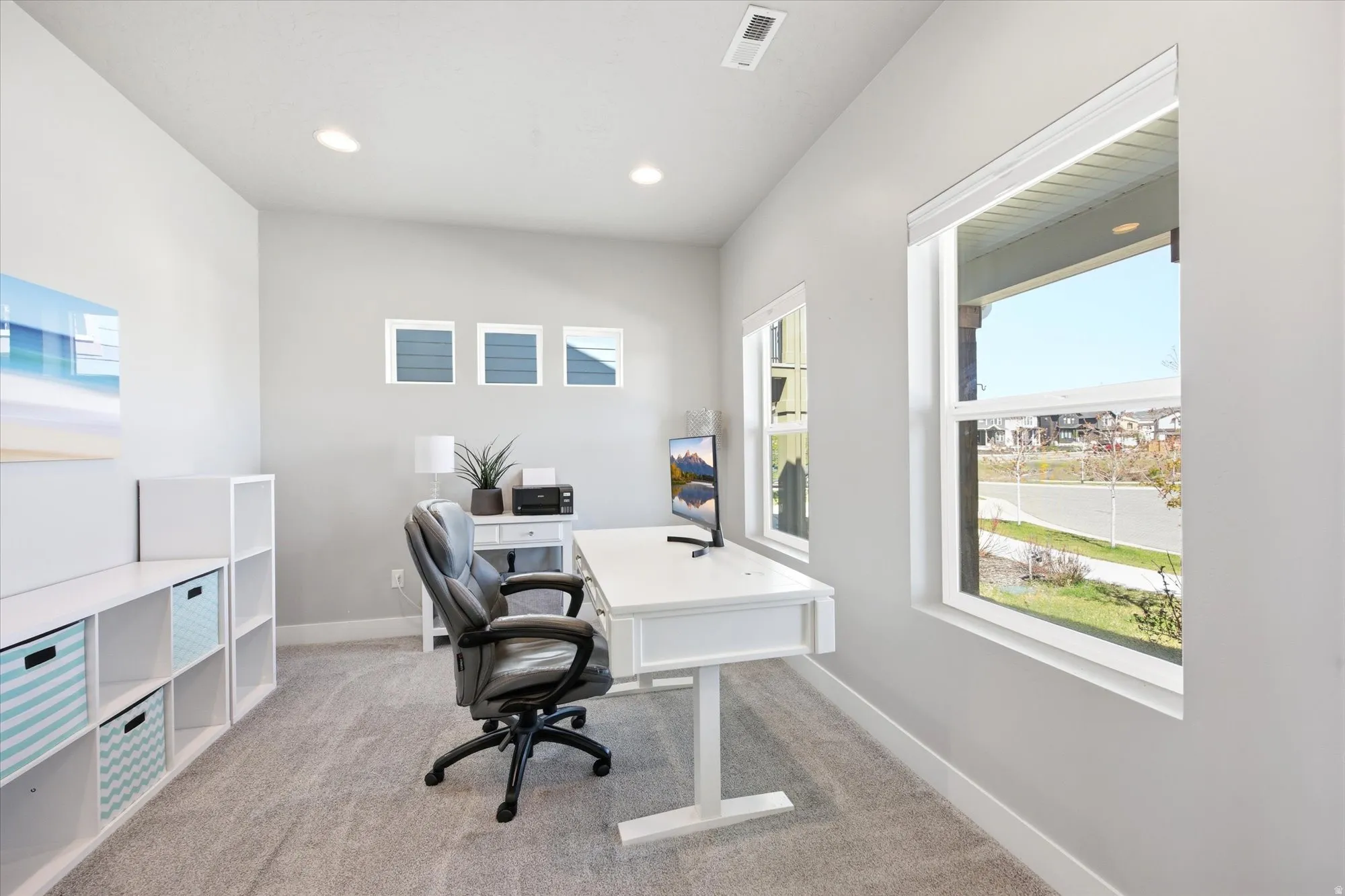 Spacious room with light gray walls and carpeted flooring