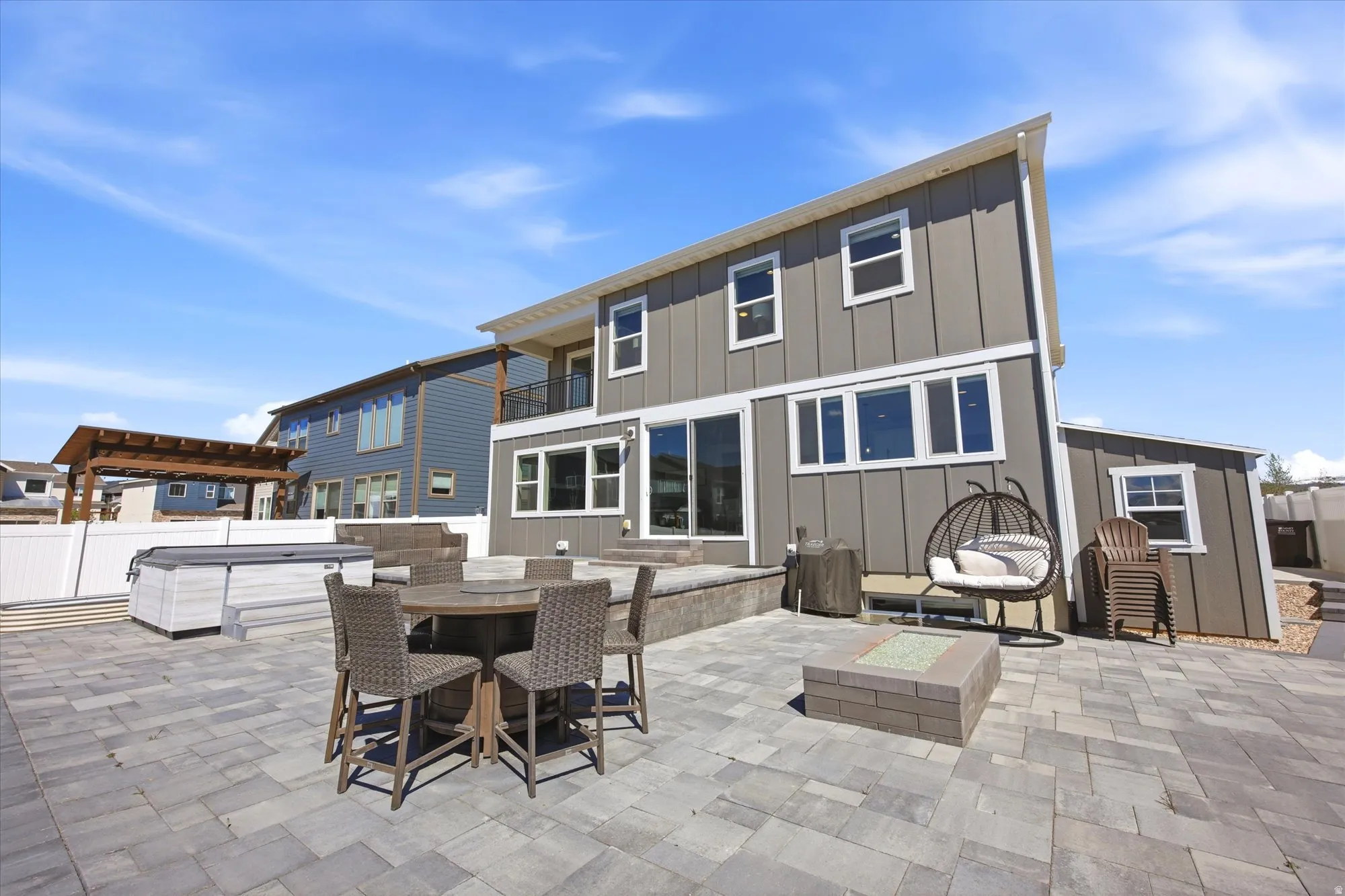 Extensive paver patio featuring a built-in fire pit