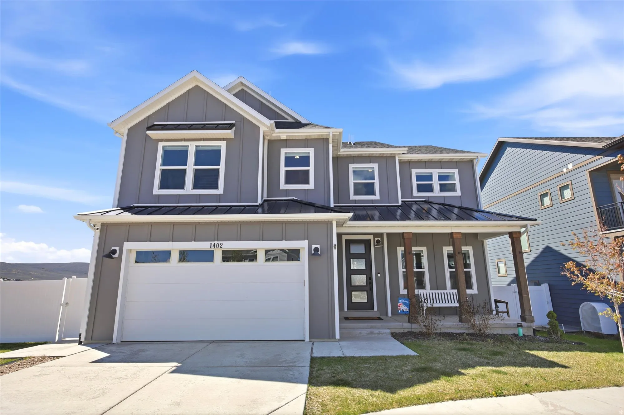Contemporary two-story residence with gray horizontal siding and white trim