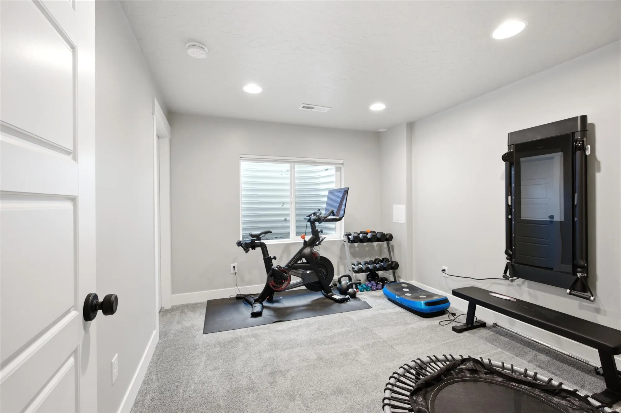 Carpeted room with recessed lighting and light gray wall paint