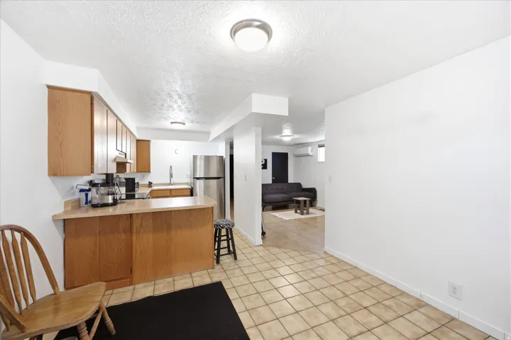 Kitchen featuring wood cabinetry, stainless steel appliances, and a breakfast bar