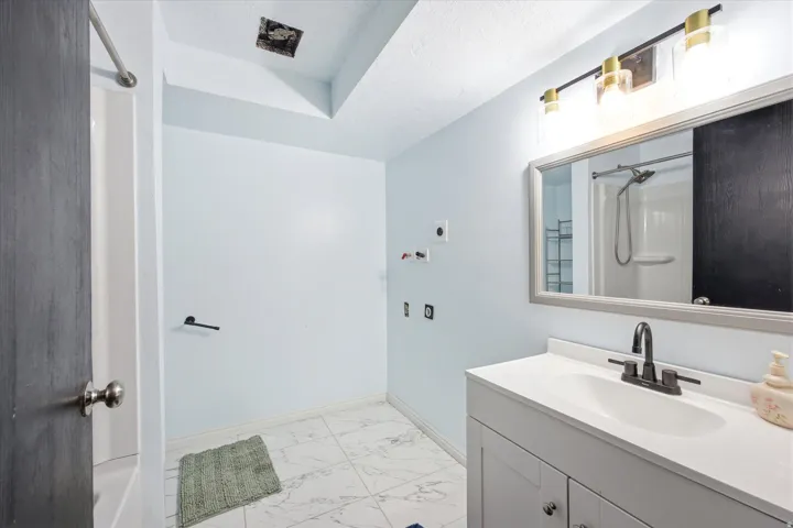 Bathroom with a single vanity, undermount sink, and dark bronze faucet