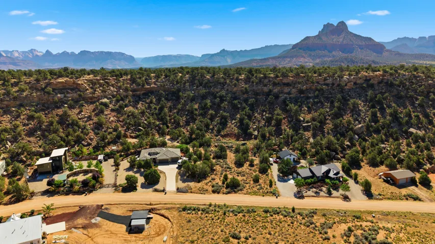 Expansive desert landscape featuring multiple properties with diverse architectural styles