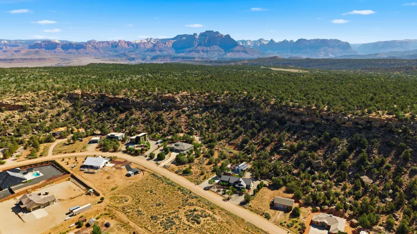 Sprawling desert landscape featuring scattered residences and mature green foliage