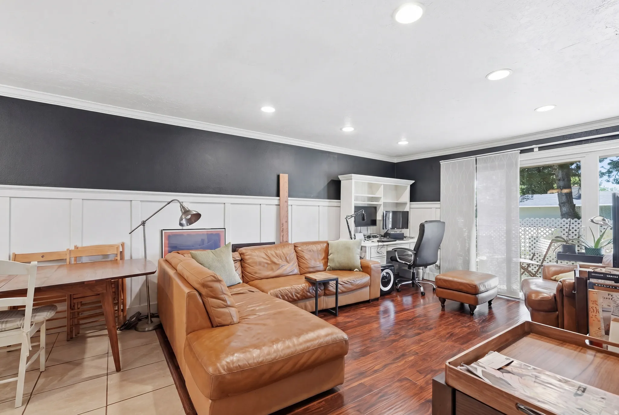 Spacious living area featuring wood-finish flooring and recessed lighting