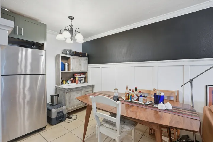 Dining area featuring wainscoting and a dark accent wall