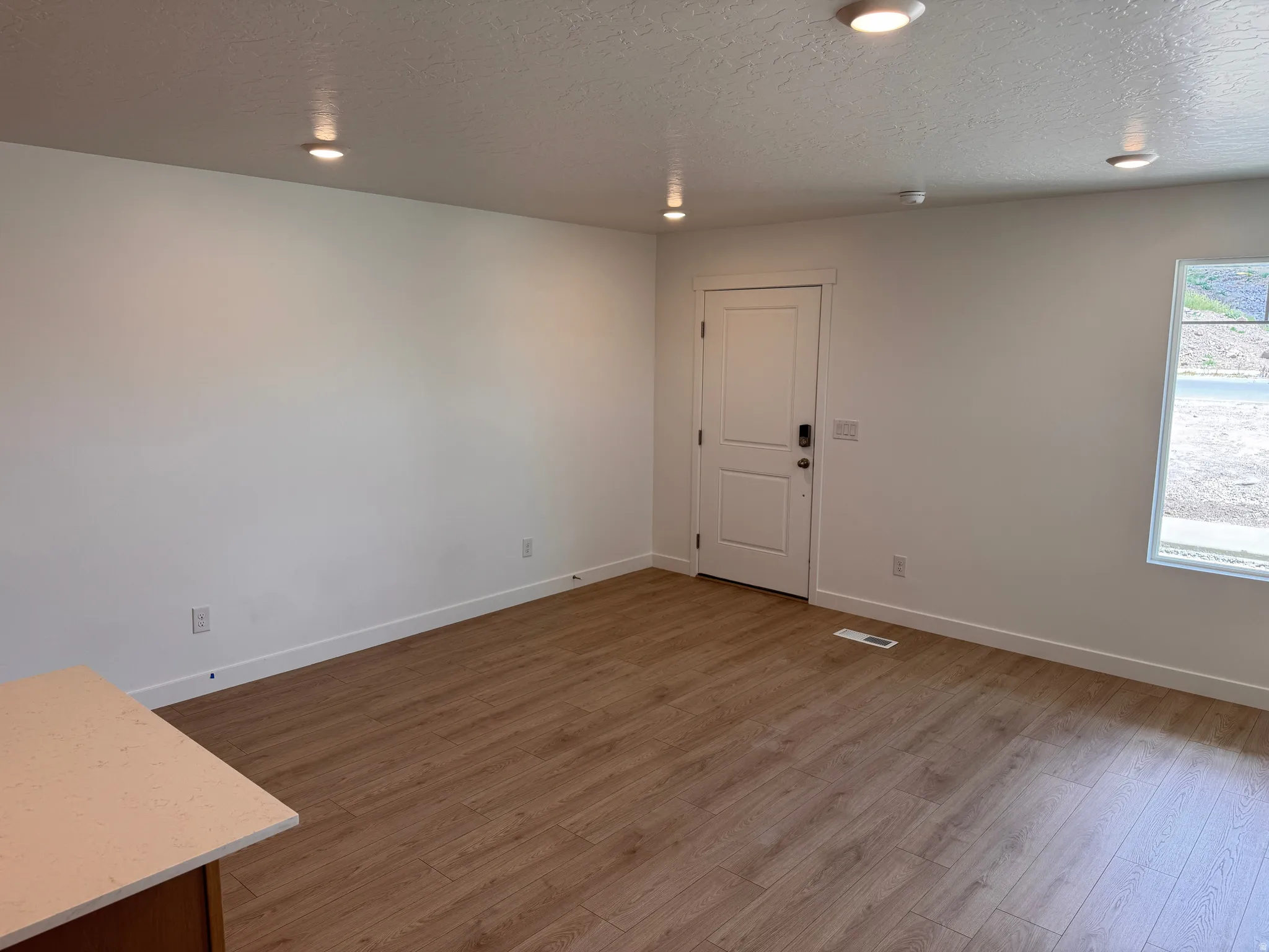 Open concept room featuring wood-finish flooring, white walls, and recessed lighting