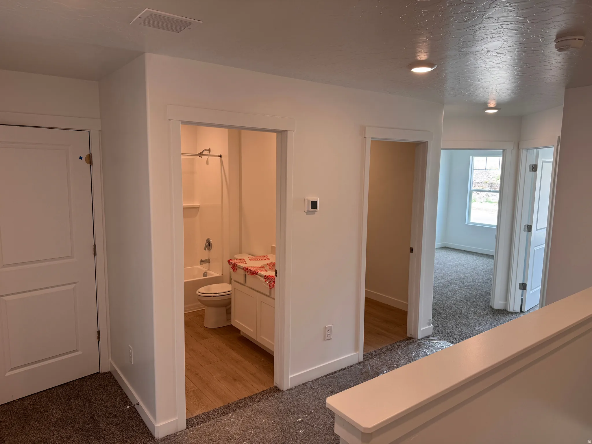 Central hallway featuring recessed lighting and neutral wall finishes