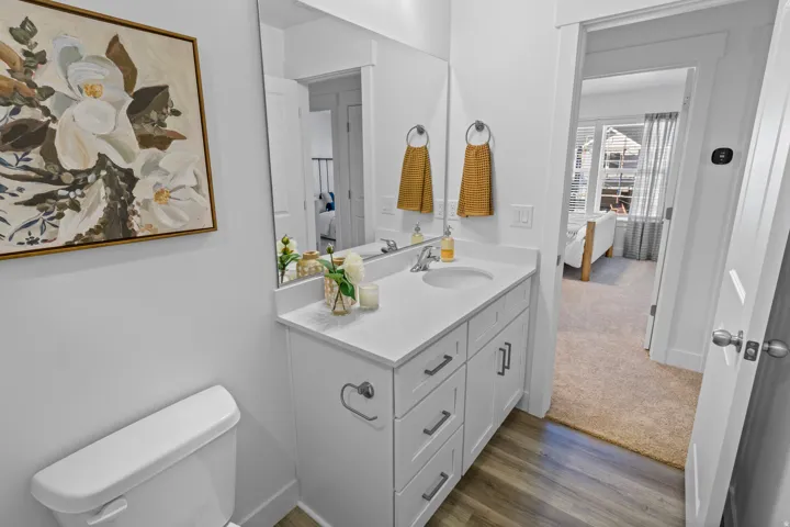Bathroom vanity with white cabinetry, a white countertop, and a rectangular undermount sink