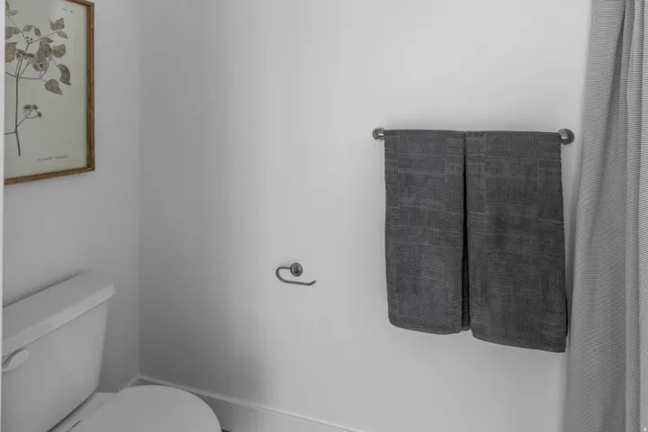 White toilet with a round bowl and a standard tank