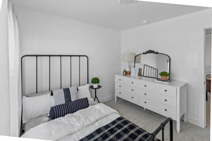 Carpeted room featuring a ceiling-mounted light fixture, white walls, and a white baseboard trim