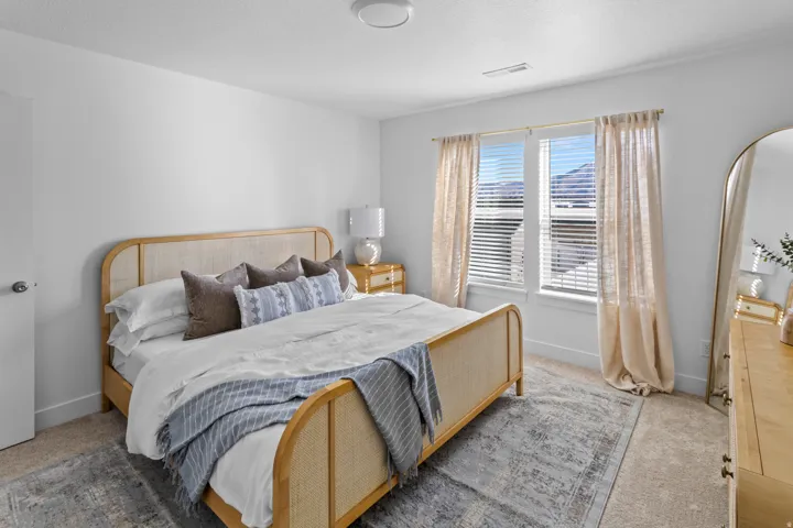 Carpeted room with white walls, a single window featuring horizontal blinds, and a flush-mount ceiling light
