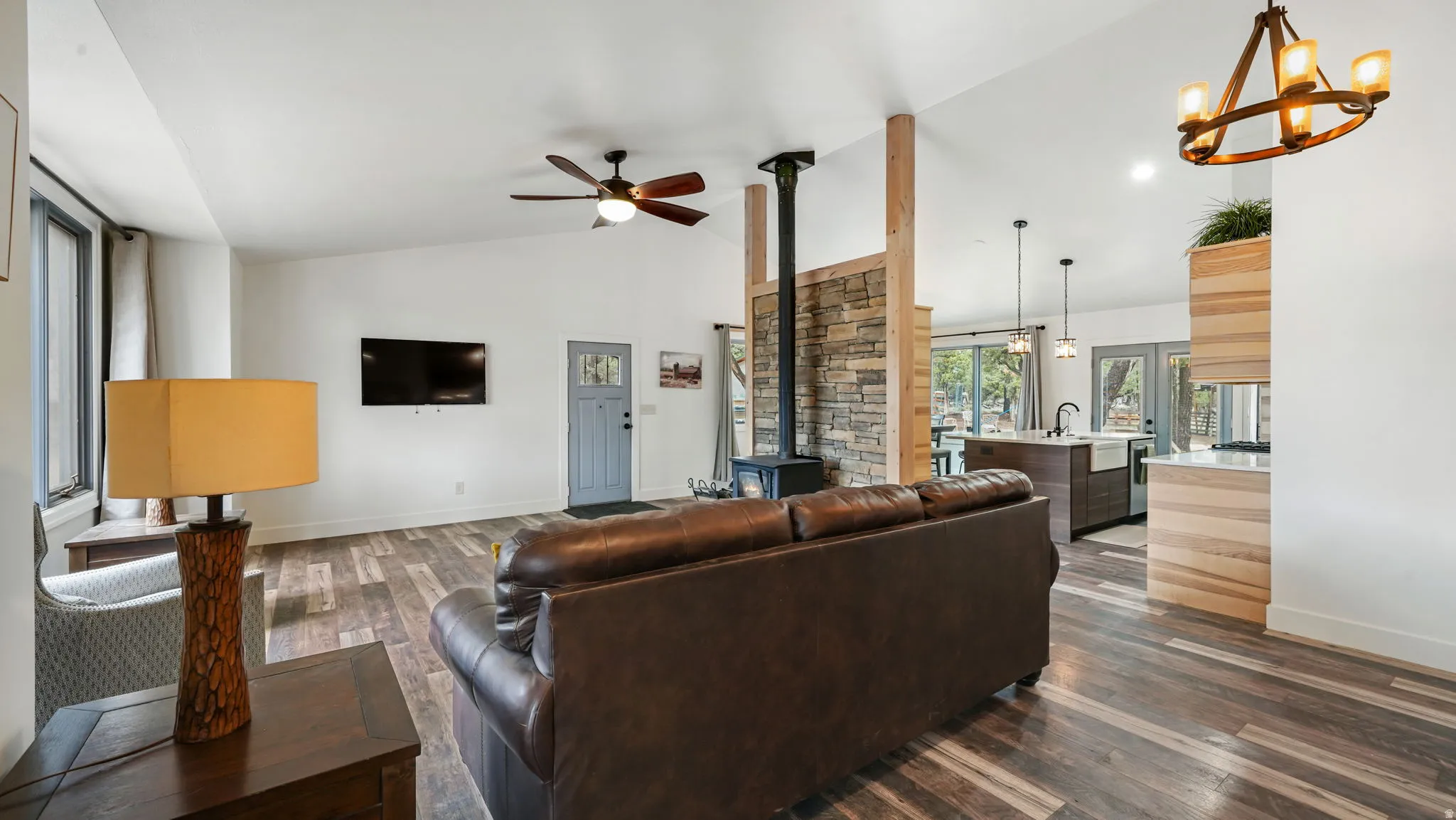 Vaulted ceilings with wood-finish flooring throughout the open-concept living area