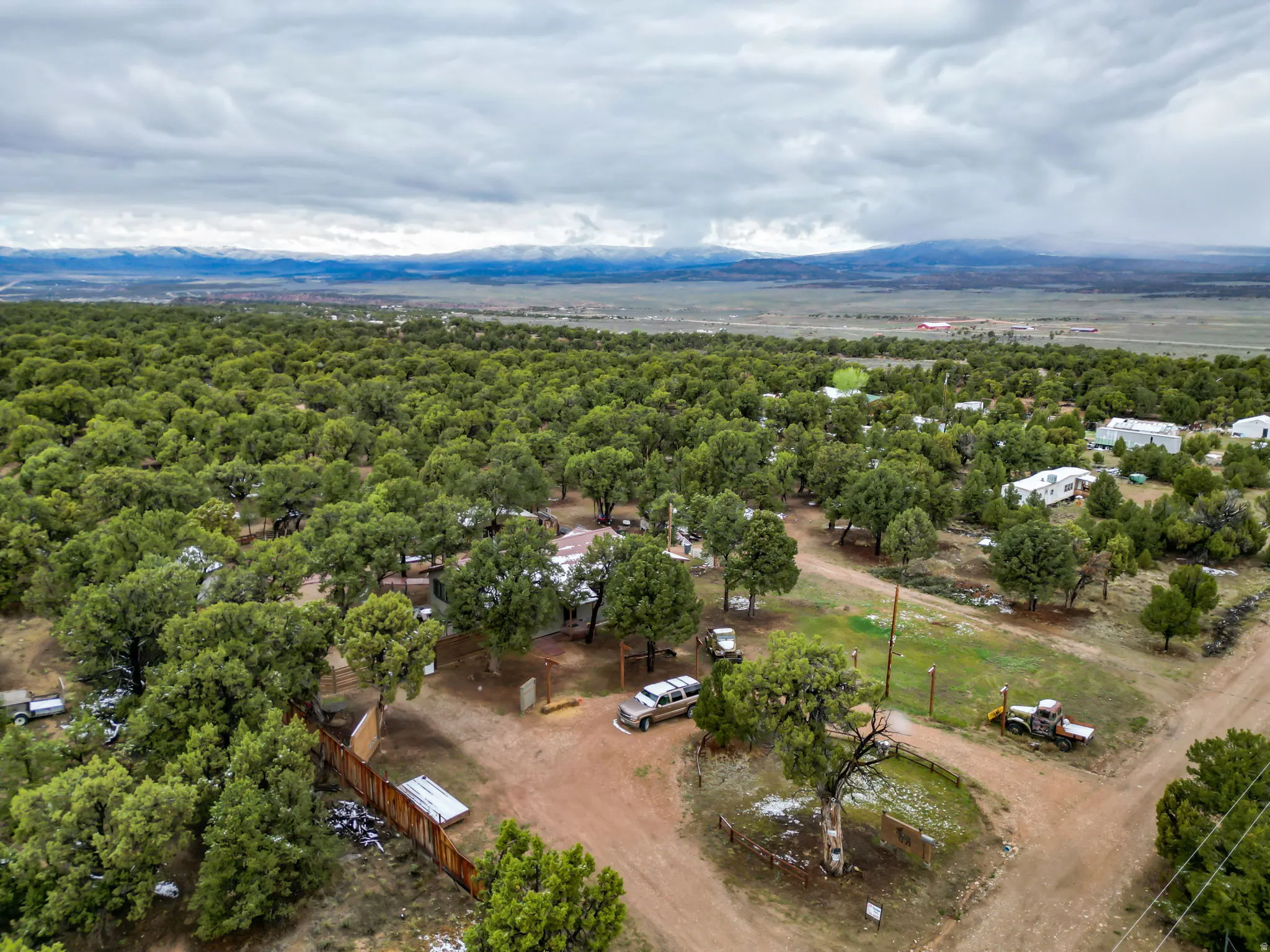 Expansive property featuring abundant mature trees, a natural landscape, and distant mountain ranges