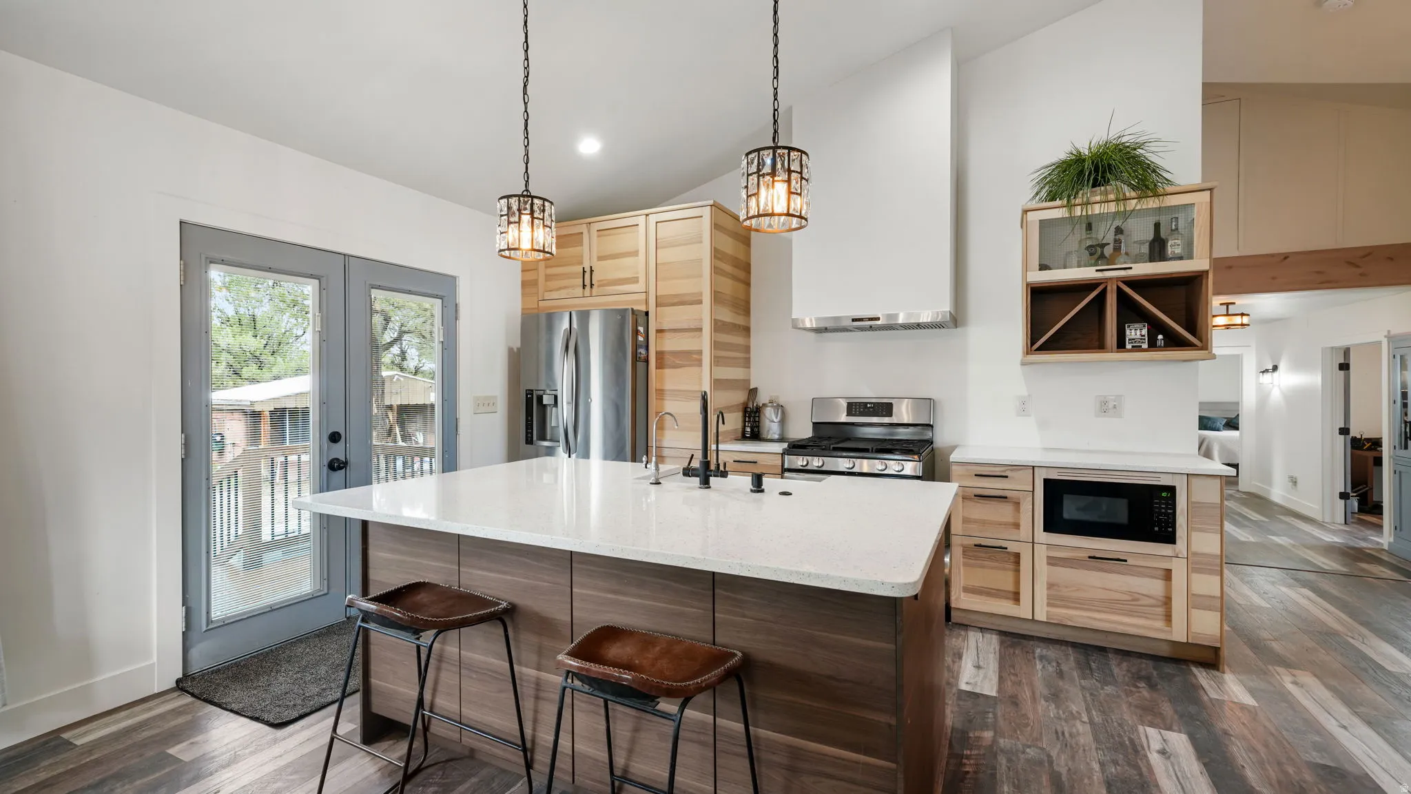 Modern kitchen with a large central island featuring a white countertop and seating