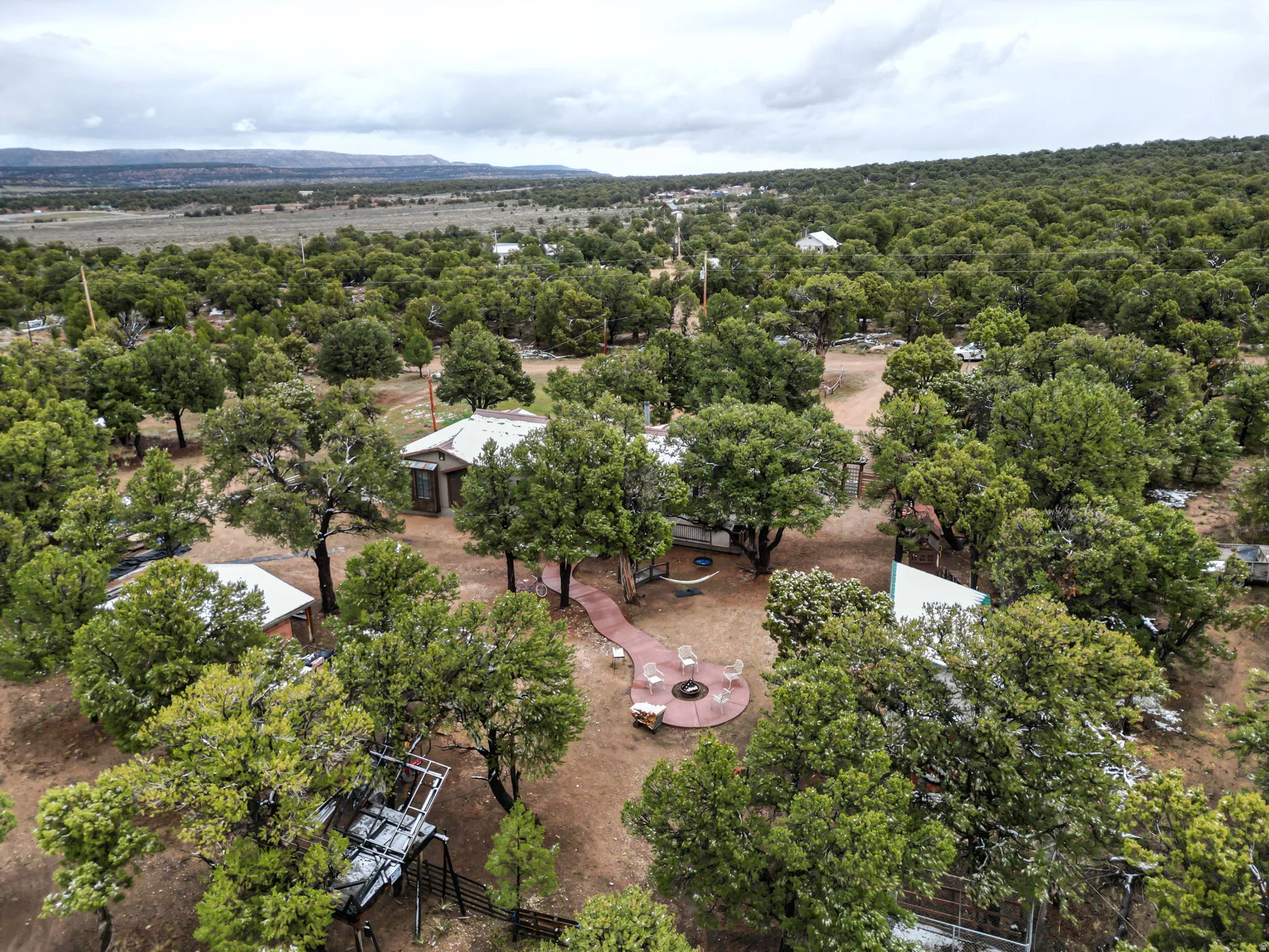 Expansive acreage featuring multiple structures amidst abundant mature trees