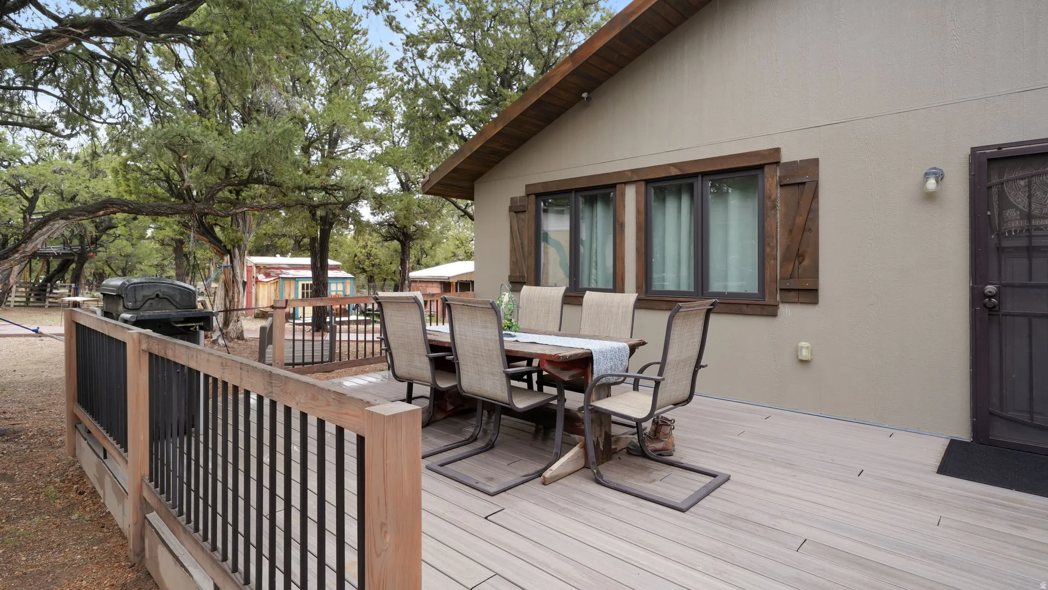 Spacious outdoor deck with composite decking and wooden railings