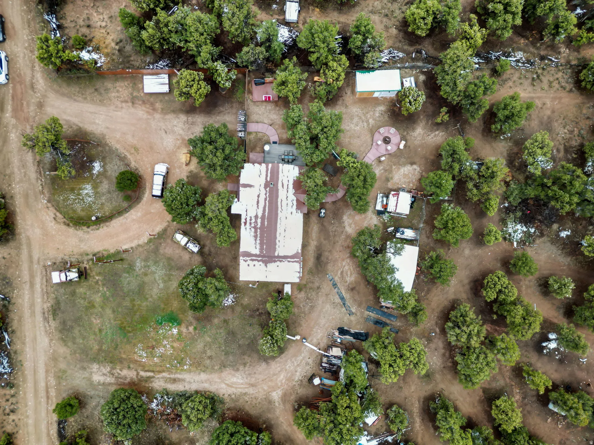 Aerial property overview featuring a main structure with a metal roof