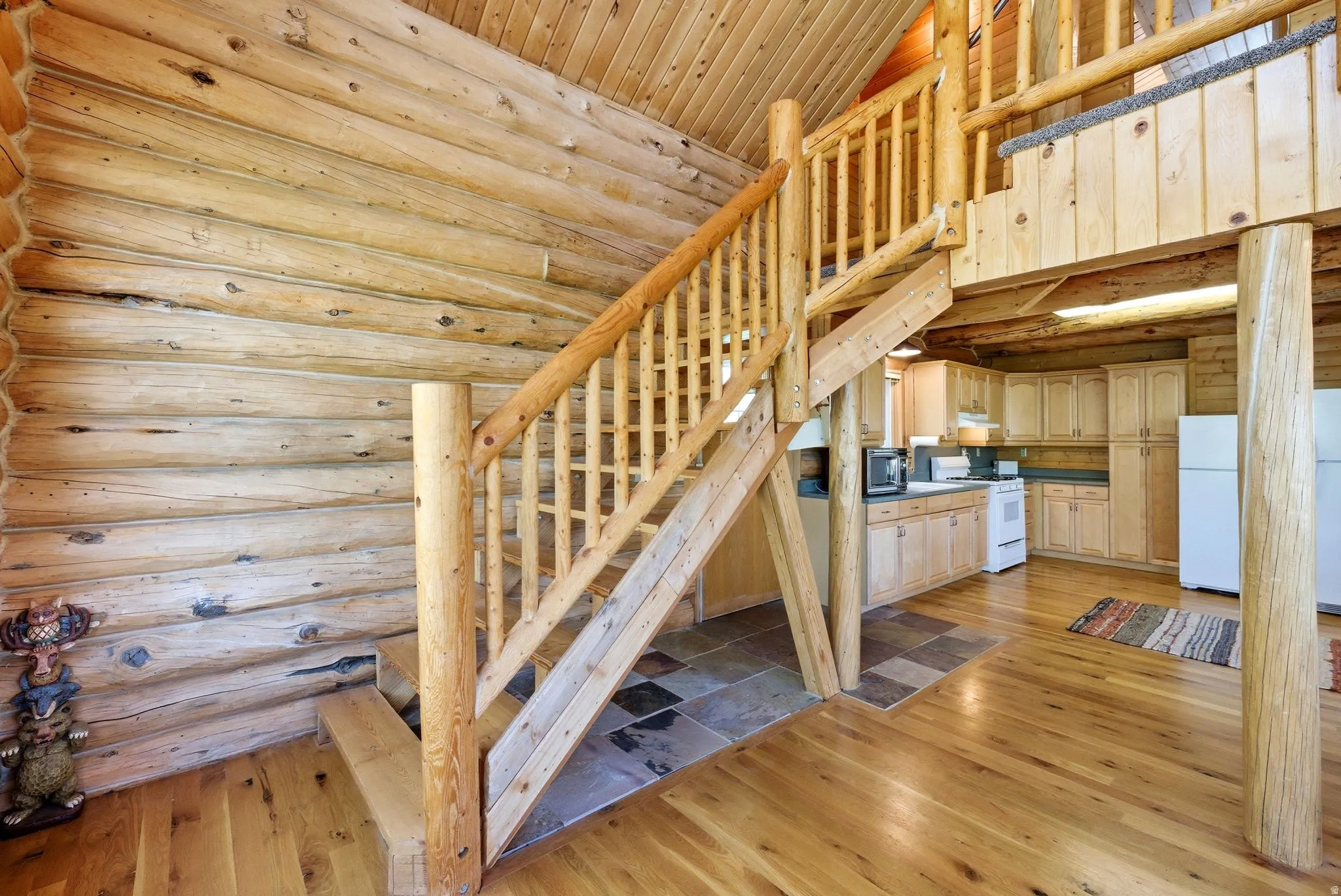 Natural wood log construction with a multi-level design featuring a wood-finish staircase