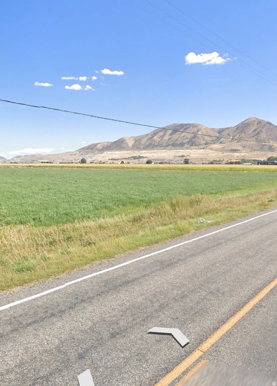 Expansive agricultural fields with distant mountains under a clear sky