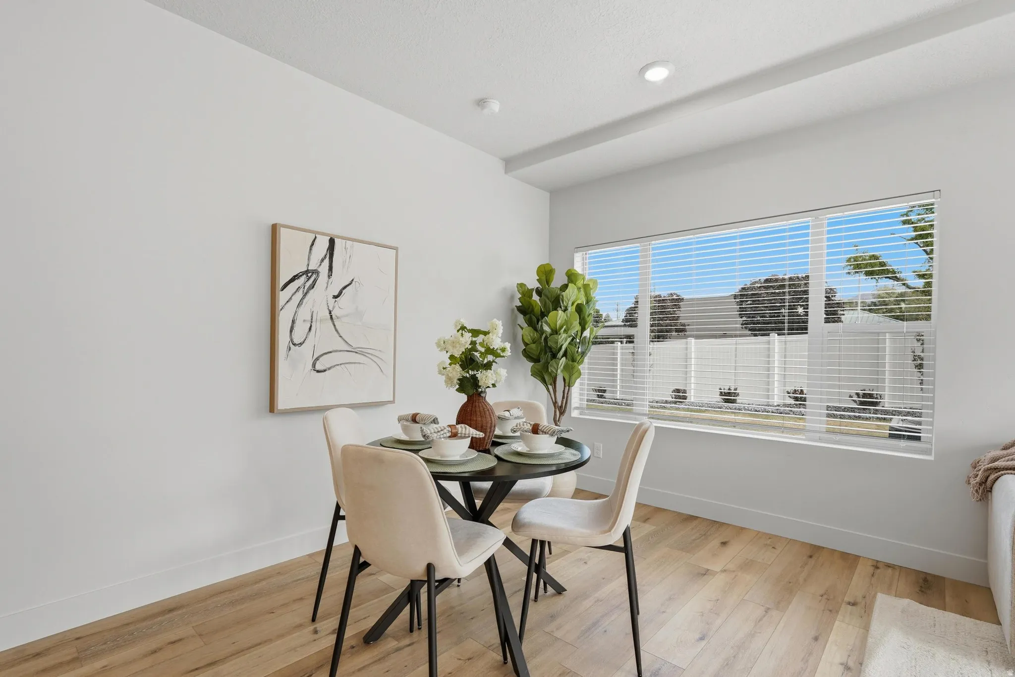 Dining area featuring wood-finish flooring, recessed lighting, and a large window with horizontal blinds