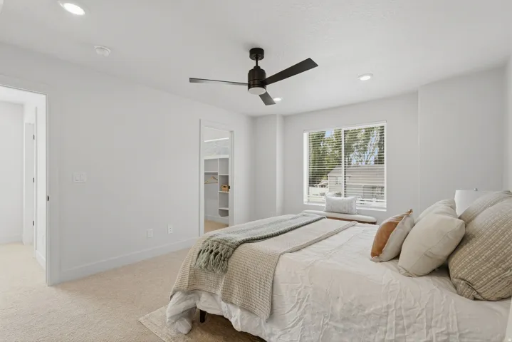 Bedroom featuring neutral carpet flooring, recessed lighting, a modern ceiling fan, and a window with blinds