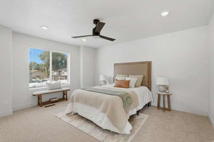 Bedroom featuring plush carpeting, a large window with blinds, recessed lighting, and a ceiling fan