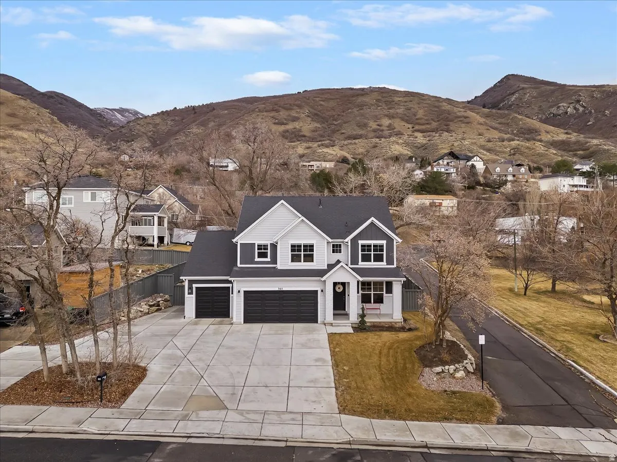 Contemporary two-story residence featuring a two-tone facade with dark siding and light trim
