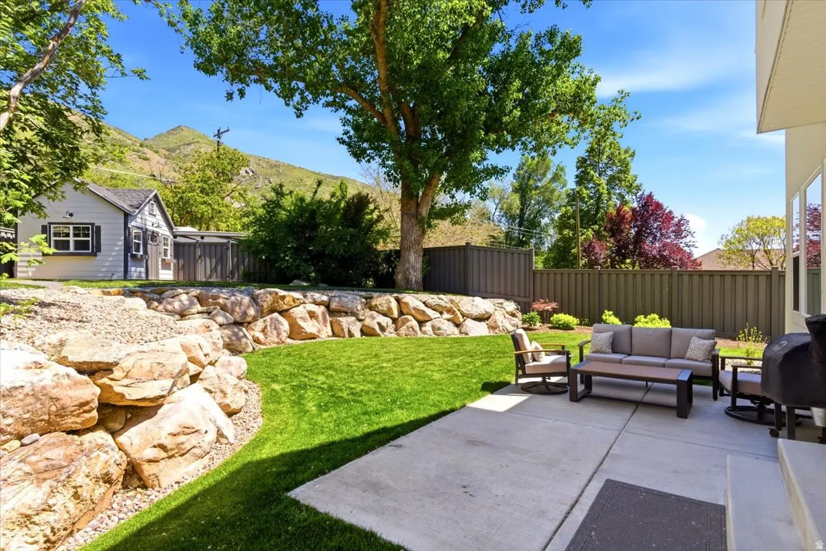 Expansive concrete patio with multiple windows overlooking the space