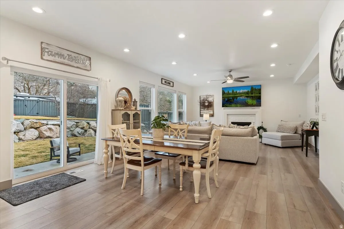 Expansive open-concept living area featuring wood-finish flooring, recessed lighting, and a ceiling fan